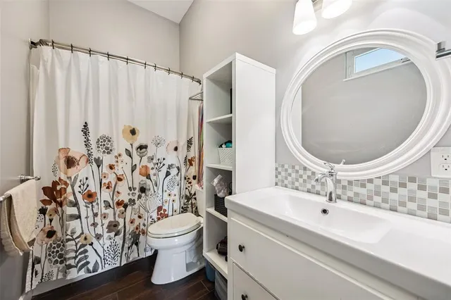 a living room with furniture tv and a floor to ceiling window