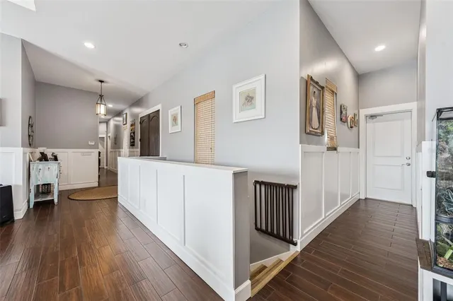 a kitchen with refrigerator cabinets and wooden floor