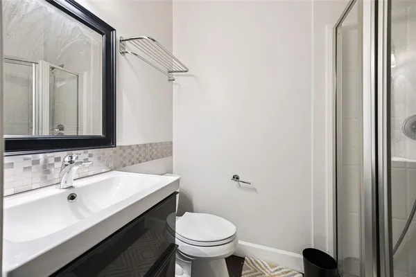 a view of a hallway with wooden floor and closet