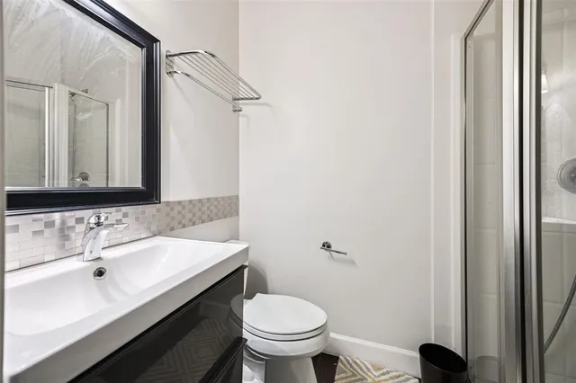 a view of a hallway with wooden floor and closet