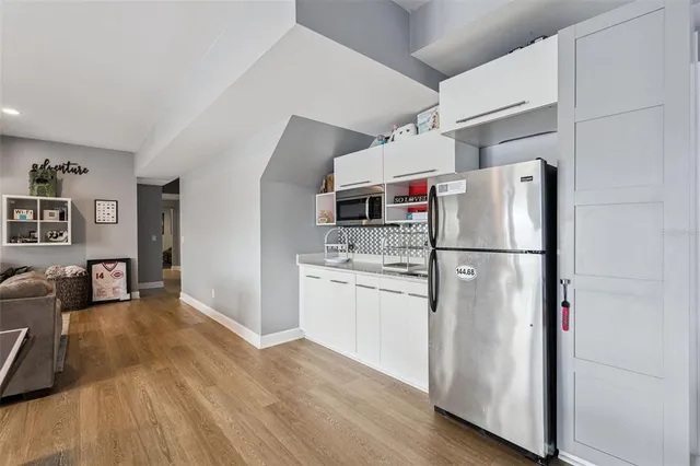 a dining room with furniture a chandelier and a large window