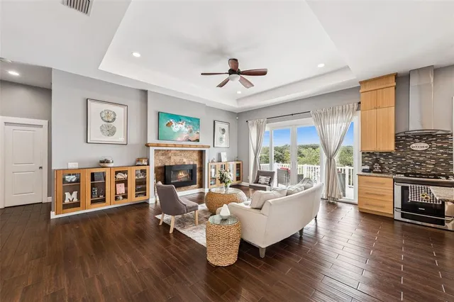a living room with fireplace furniture and a wooden floor