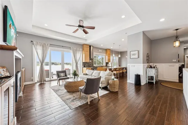 a living room with furniture dining table and wooden floor
