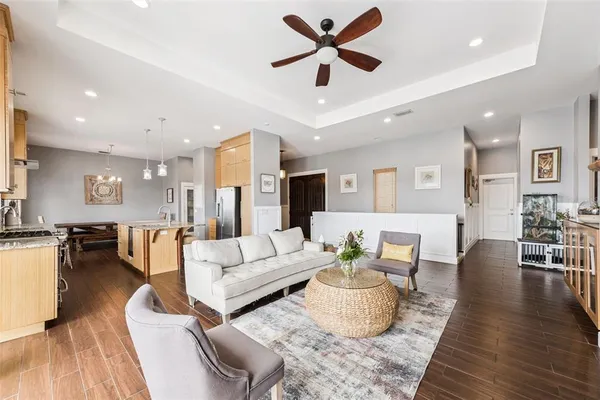 a living room with furniture and a wooden floor