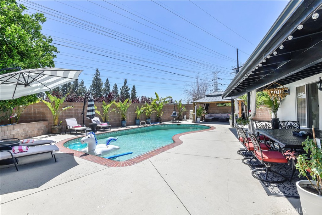 9728 Rhea Avenue Northridge, CA 91324 - Photo 29 of 36 a view of a patio with a table and chairs and potted plants