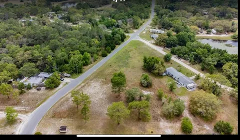 an aerial view of a residential houses with outdoor space and street view