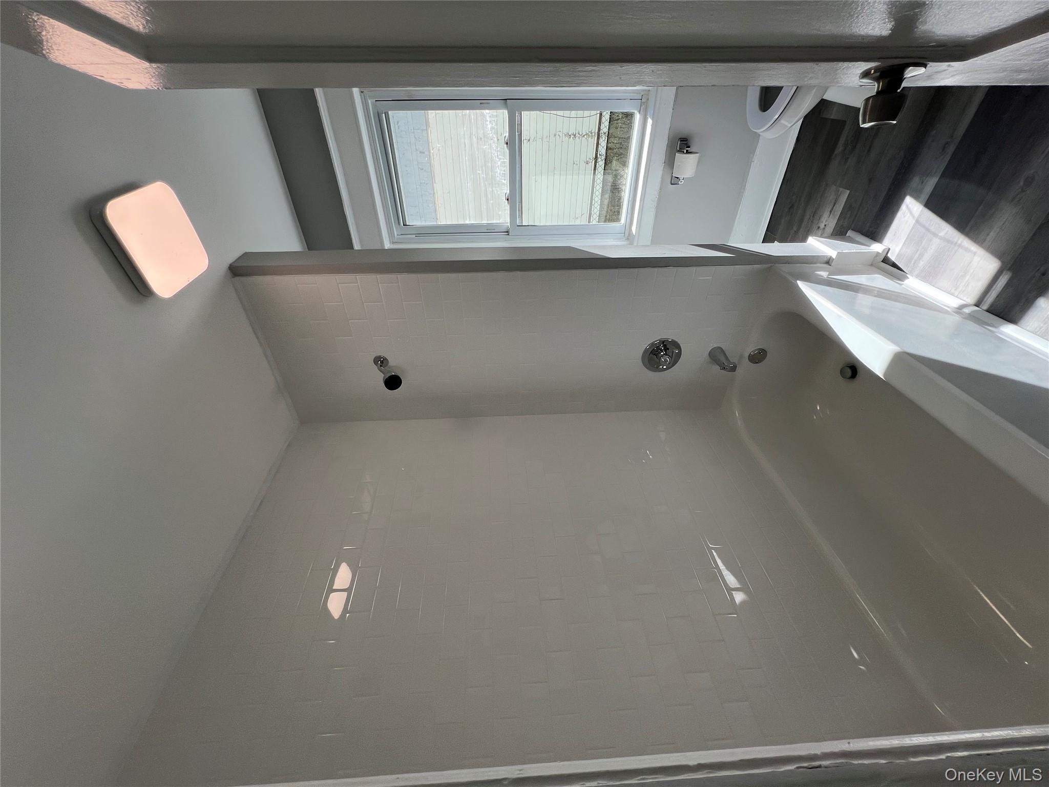 46 Manitou Avenue, Unit 1 Poughkeepsie, NY 12603 - Photo 13 of 15 Bathroom featuring shower / bathtub combination and dark wood finished floors