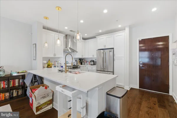 a kitchen with stainless steel appliances a sink and a refrigerator