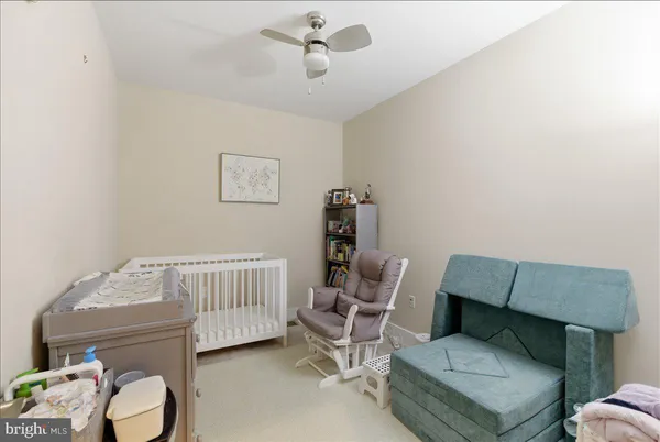 a bedroom with furniture and a chair