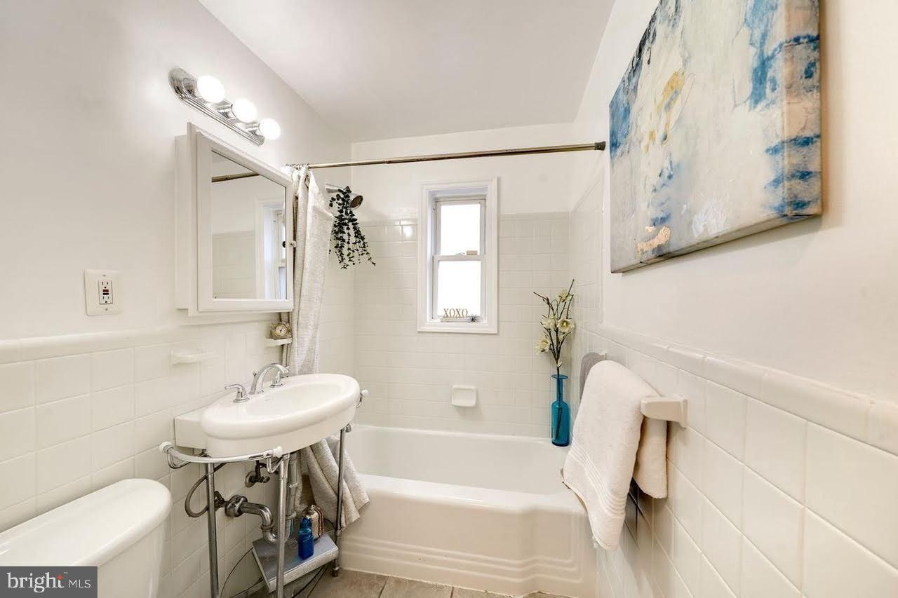 1320 Missouri Avenue Northwest, Unit 203 Washington, DC 20011 - Photo 22 of 37 a bathroom with a sink a toilet and a bathtub