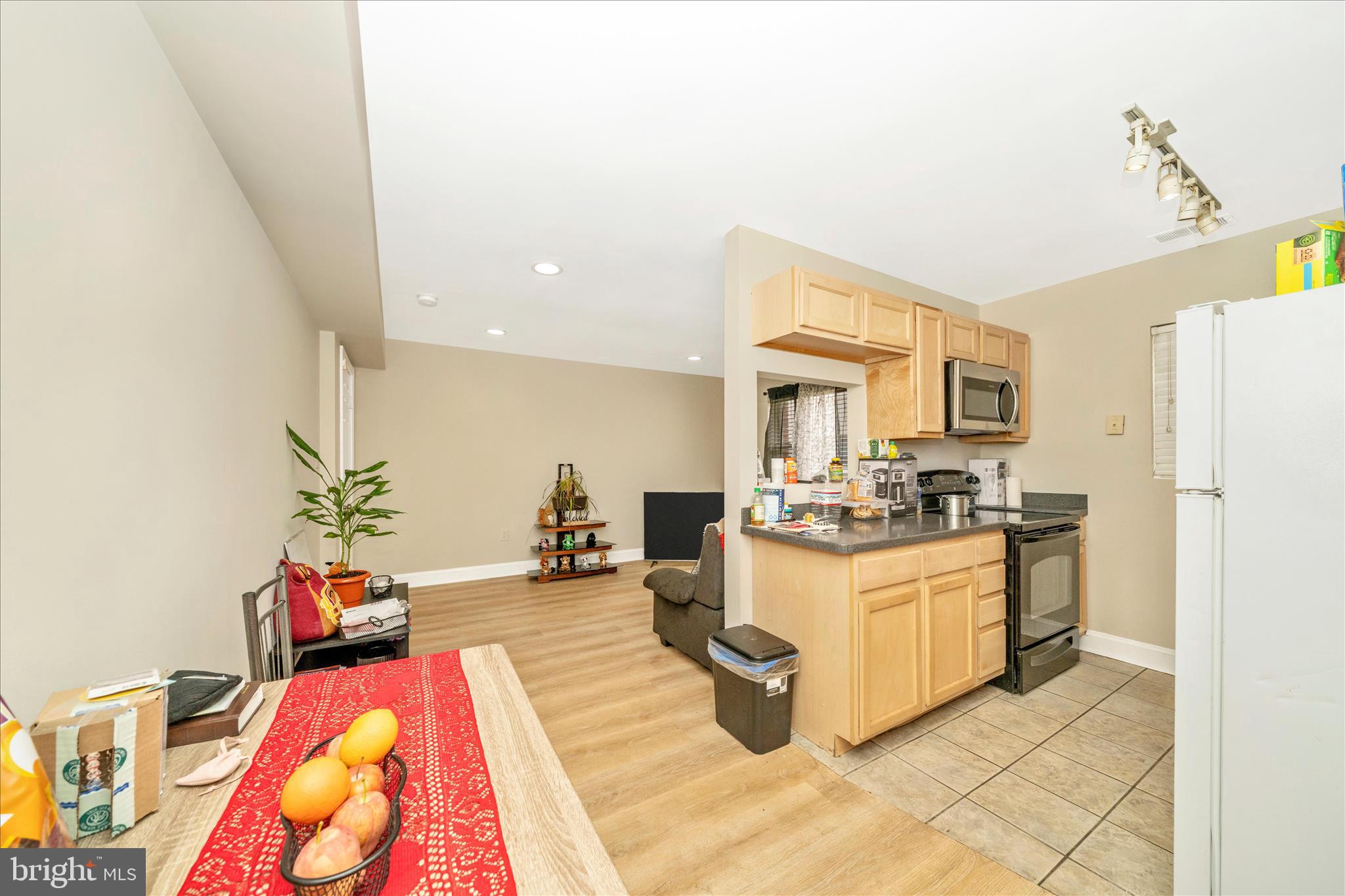 1320 Missouri Avenue Northwest, Unit 203 Washington, DC 20011 - Photo 9 of 37 a living room with stainless steel appliances furniture a rug and a kitchen view