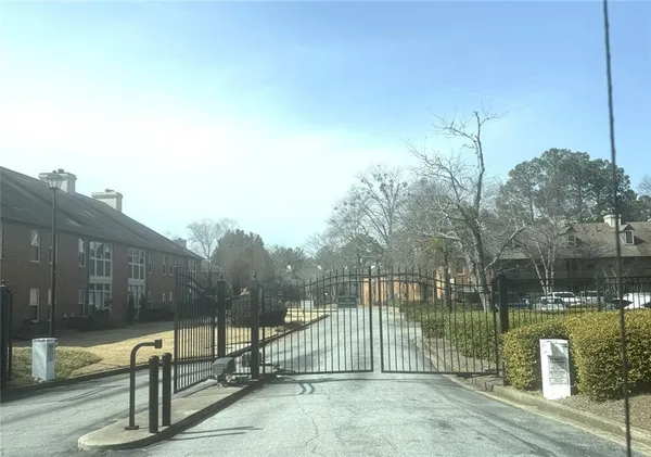 a view of a park with iron fence