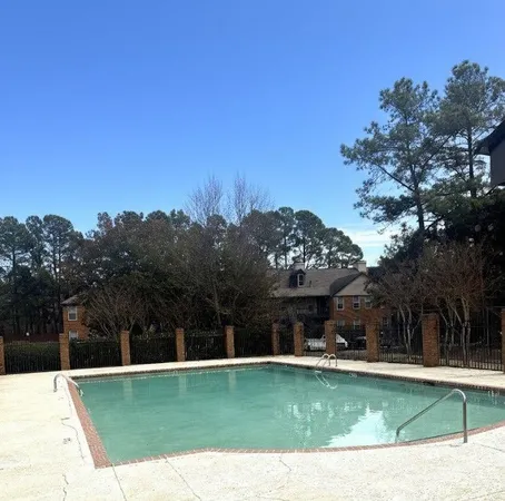 a swimming pool with outdoor seating and yard