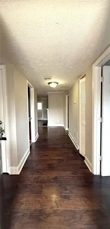 a view of hallway with wooden floor