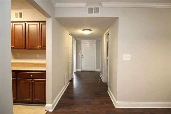 a view of a hallway with wooden floor