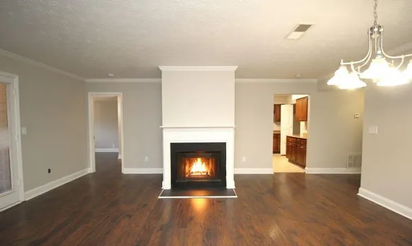 a view of a livingroom with a fireplace wooden floor and fire place