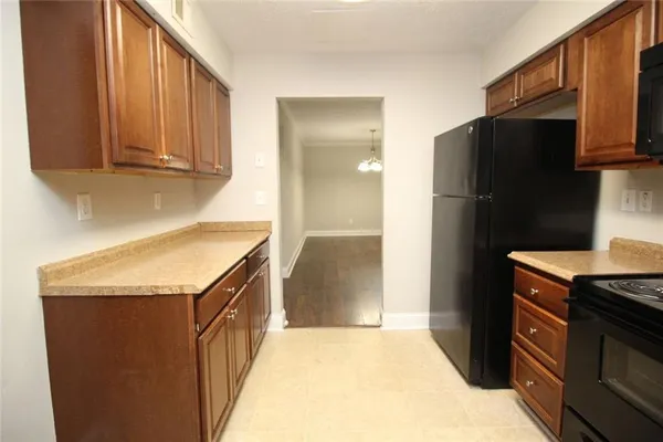 a kitchen with stainless steel appliances granite countertop a refrigerator and a stove