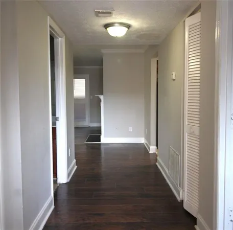 a view of a hallway with wooden floor