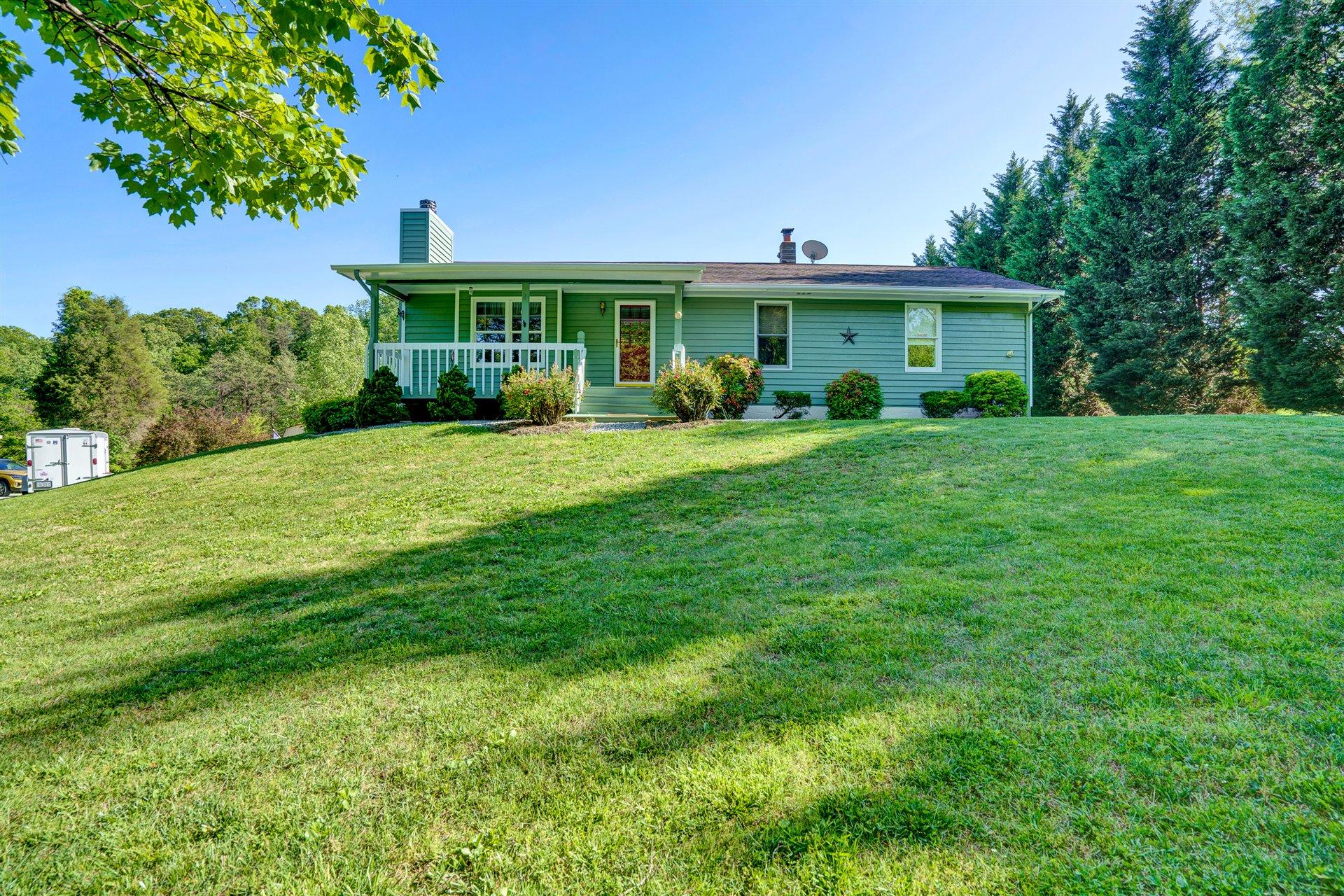 1401 Treasure Lane Blue Ridge, VA 24064 - Photo 1 of 23 a front view of a house with a garden