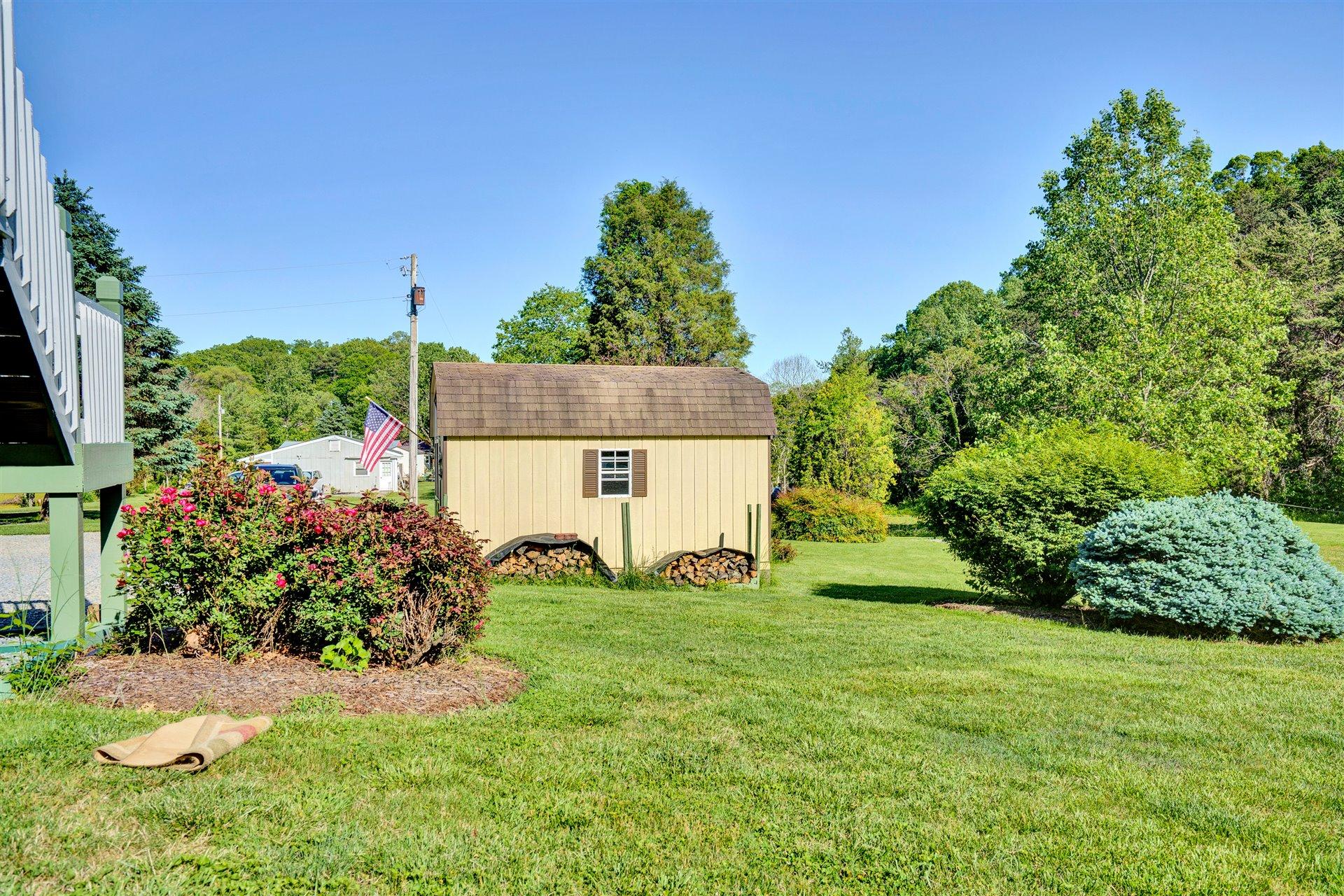 1401 Treasure Lane Blue Ridge, VA 24064 - Photo 20 of 23 a view of a house with a yard and potted plants