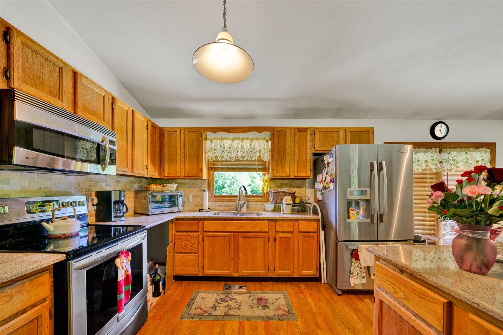 1401 Treasure Lane Blue Ridge, VA 24064 - Photo 7 of 23 a kitchen that has a lot of cabinets a sink and a stove