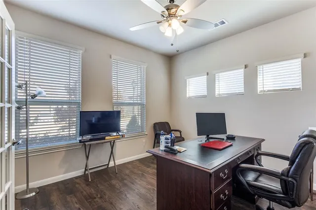 a view of a workspace with furniture and a window