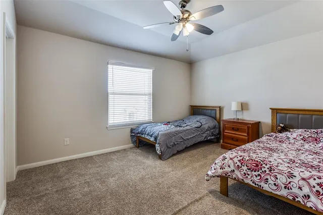 a bedroom with two beds and painting on the wall
