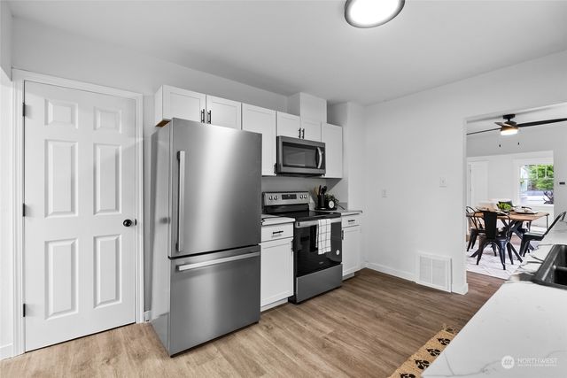 a kitchen with stainless steel appliances granite countertop a refrigerator microwave and stove