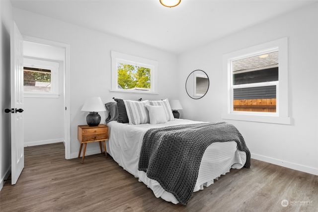 a bedroom with a bed and wooden floor