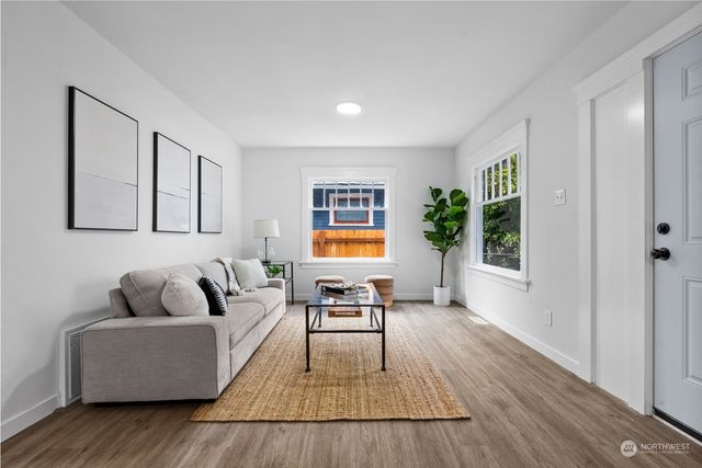 a living room with furniture and a potted plant