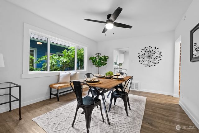 a view of a dining room with furniture window and wooden floor