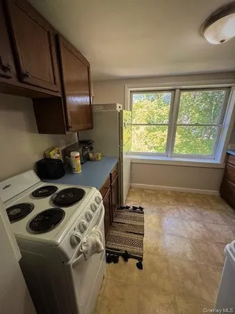 a kitchen with a stove a sink and a refrigerator