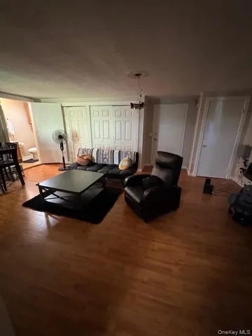 a living room with furniture pool table and a window