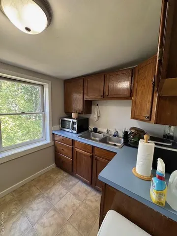 a kitchen with a stove a sink and a cabinets