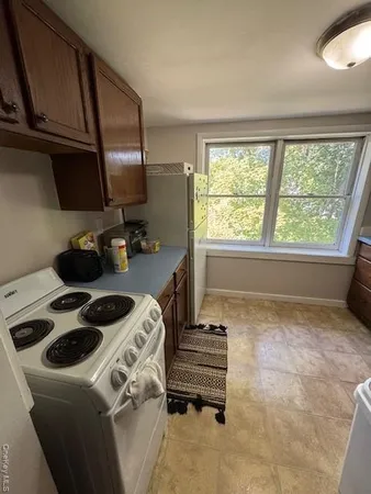 a kitchen with a stove a sink and a refrigerator