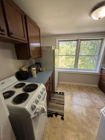 a kitchen with a stove a sink and a refrigerator