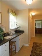 4517 Chandler Road Hermitage, TN 37076 - Photo 20 of 20 Laundry and Work Area: 11 x 6 Located on the main level and between the Kitchen and Master Suite –this area features tile flooring, your washer and dryer hookups, and a large built-in work station with base cabinets and drawers with knee space are