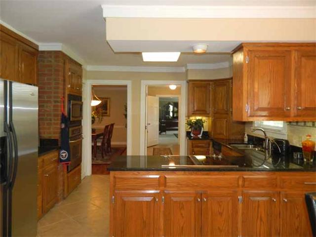 4517 Chandler Road Hermitage, TN 37076 - Photo 3 of 20 Kchen: 22x12 freshly renovated with new tile flooring, new granite tops, new tiled backsplash, new stainless appliances, recessed lighting, under cabinet lighting, new fixtures, sink and hardware, new cabinets, and crown molding.