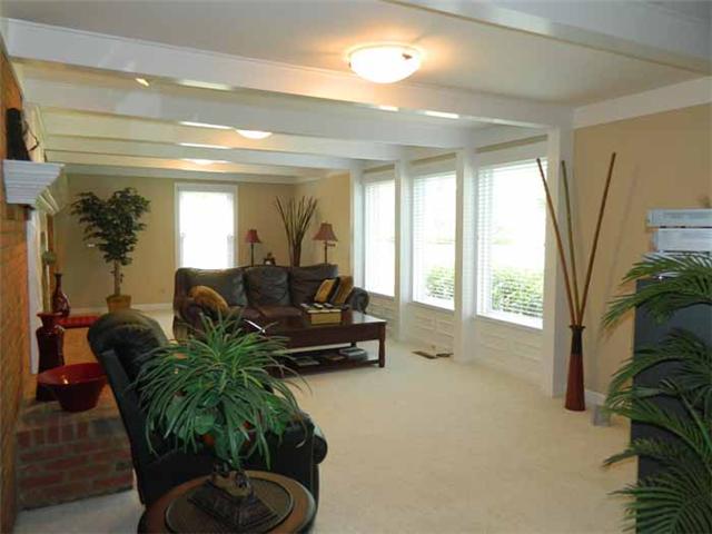 4517 Chandler Road Hermitage, TN 37076 - Photo 10 of 20 Great Room: 30 x 13 featuring detailed trim, recessed accent lighting, gas fireplace with logs, brick hearth & custom mantle, beamed ceiling, oversized windows with wood blinds, wainscoting below & detailed trim, new carpet & freshly painted