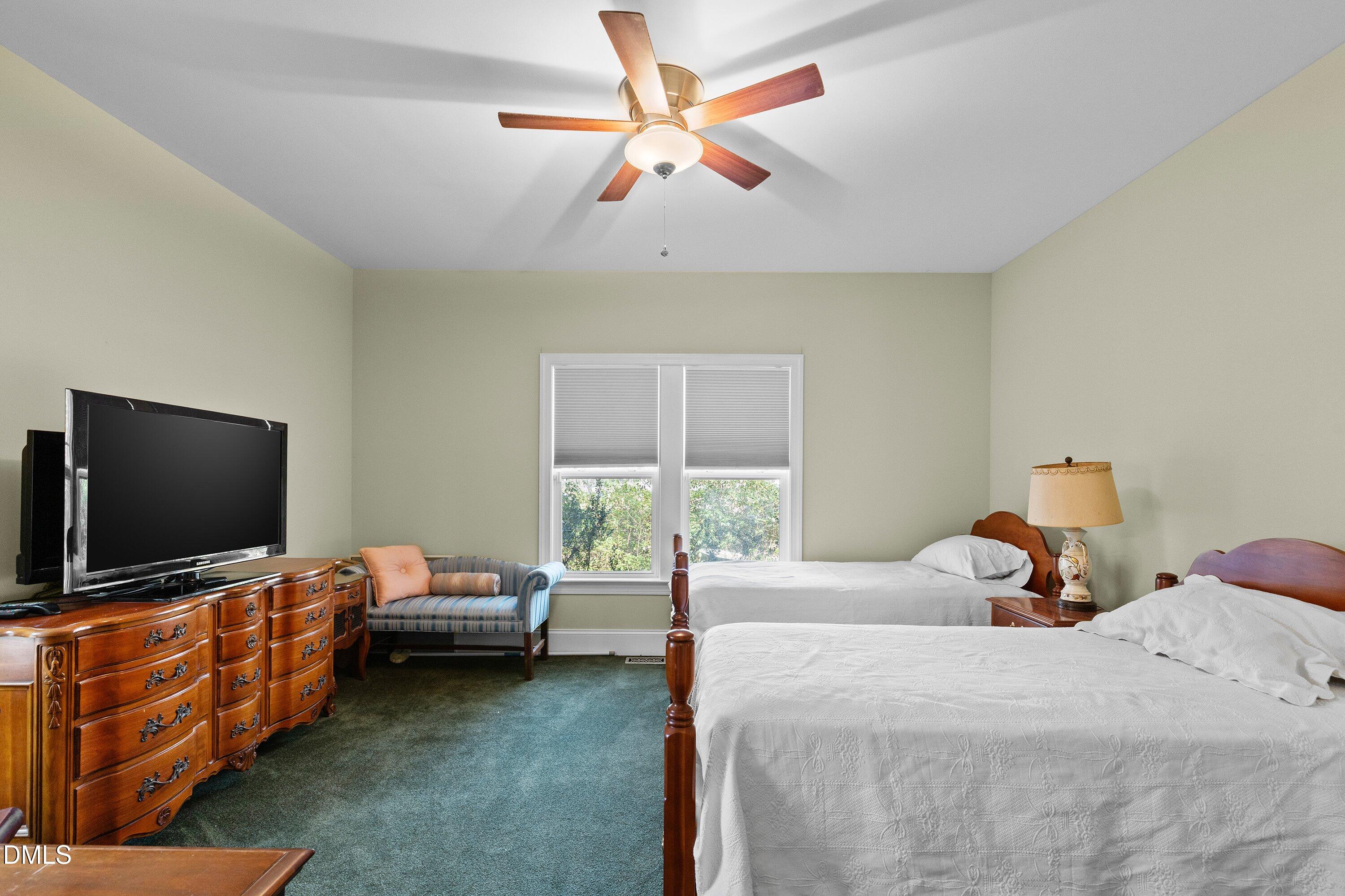 9713 Lake Wheeler Road Raleigh, NC 27603 - Photo 13 of 18 a bedroom with a bed and a flat screen tv