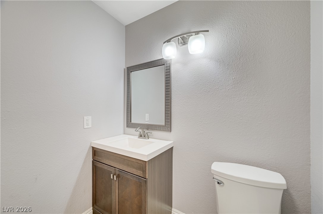 6635 Costa Brava Road Las Vegas, NV 89146 - Photo 24 of 59 A well-appointed bathroom with a vanity and modern lighting fixture, perfect for daily routines.