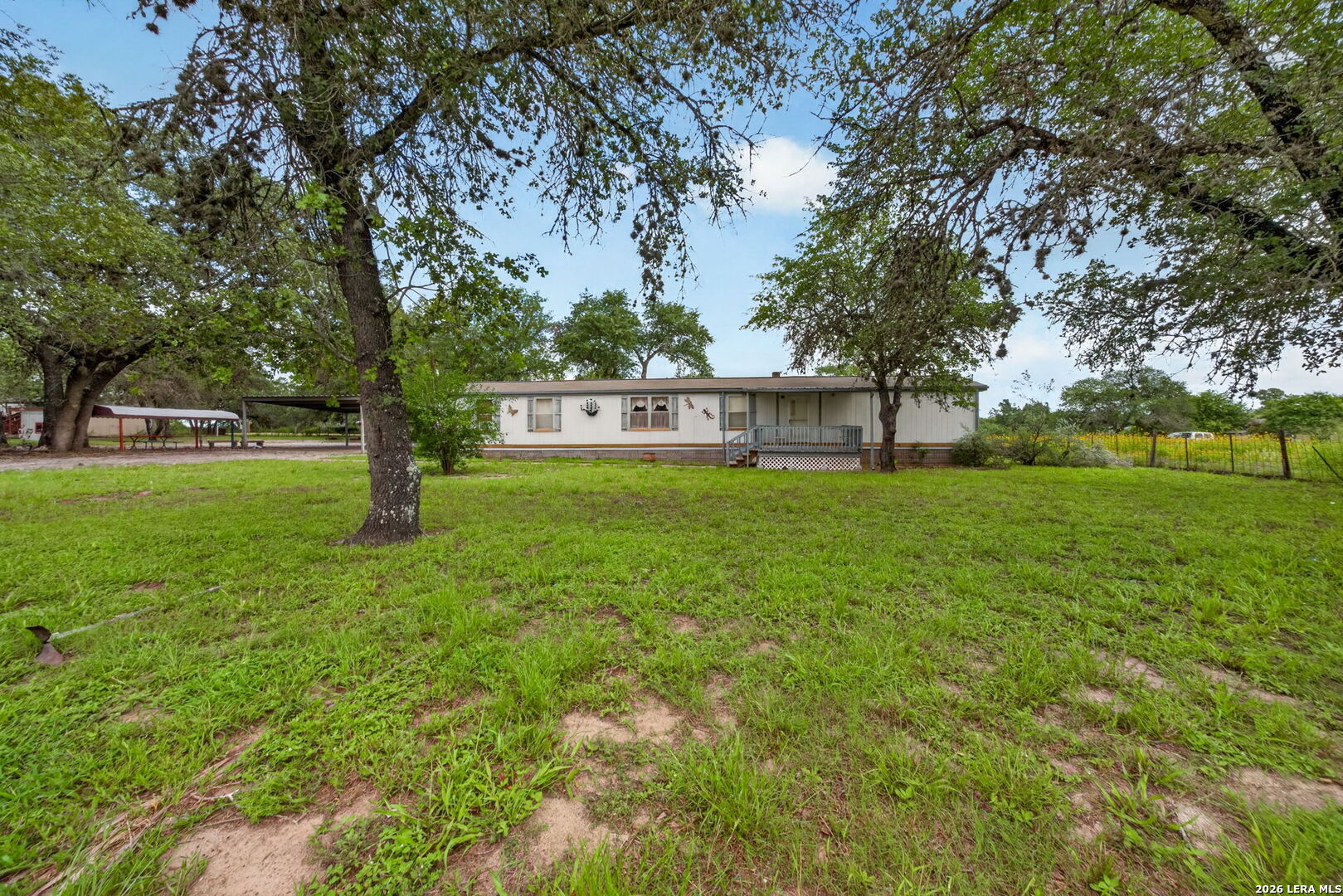 23398 Mathis Road Elmendorf, TX 78112 - Photo 1 of 18 a view of a house with a backyard