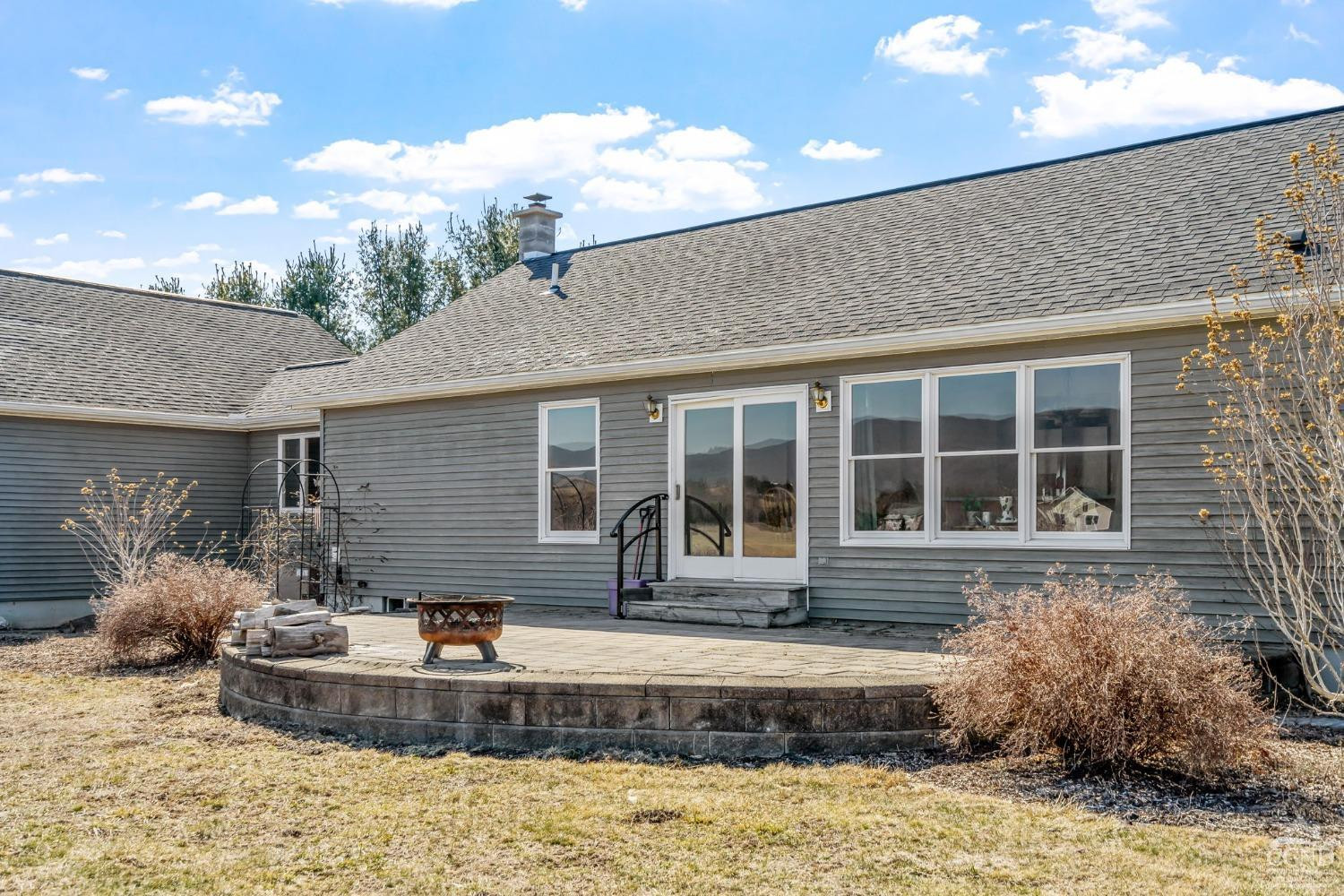 a front view of a house with a yard and outdoor seating