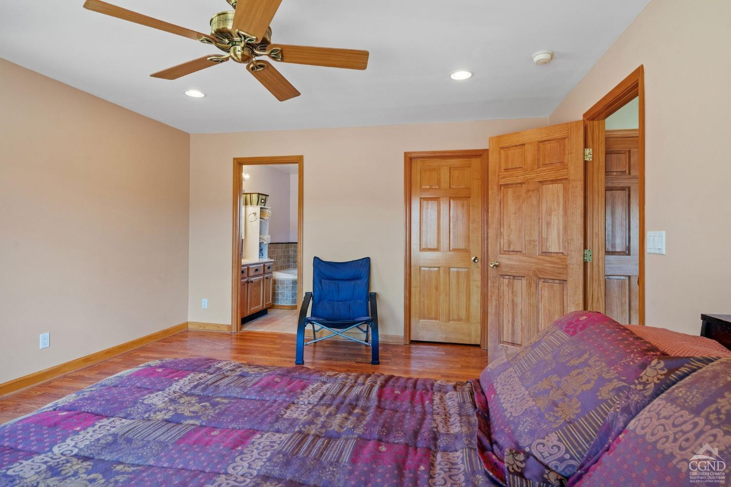 16 Deerfield Circle Copake, NY 12516 - Photo 12 of 40 a spacious bedroom with a bed and a chair