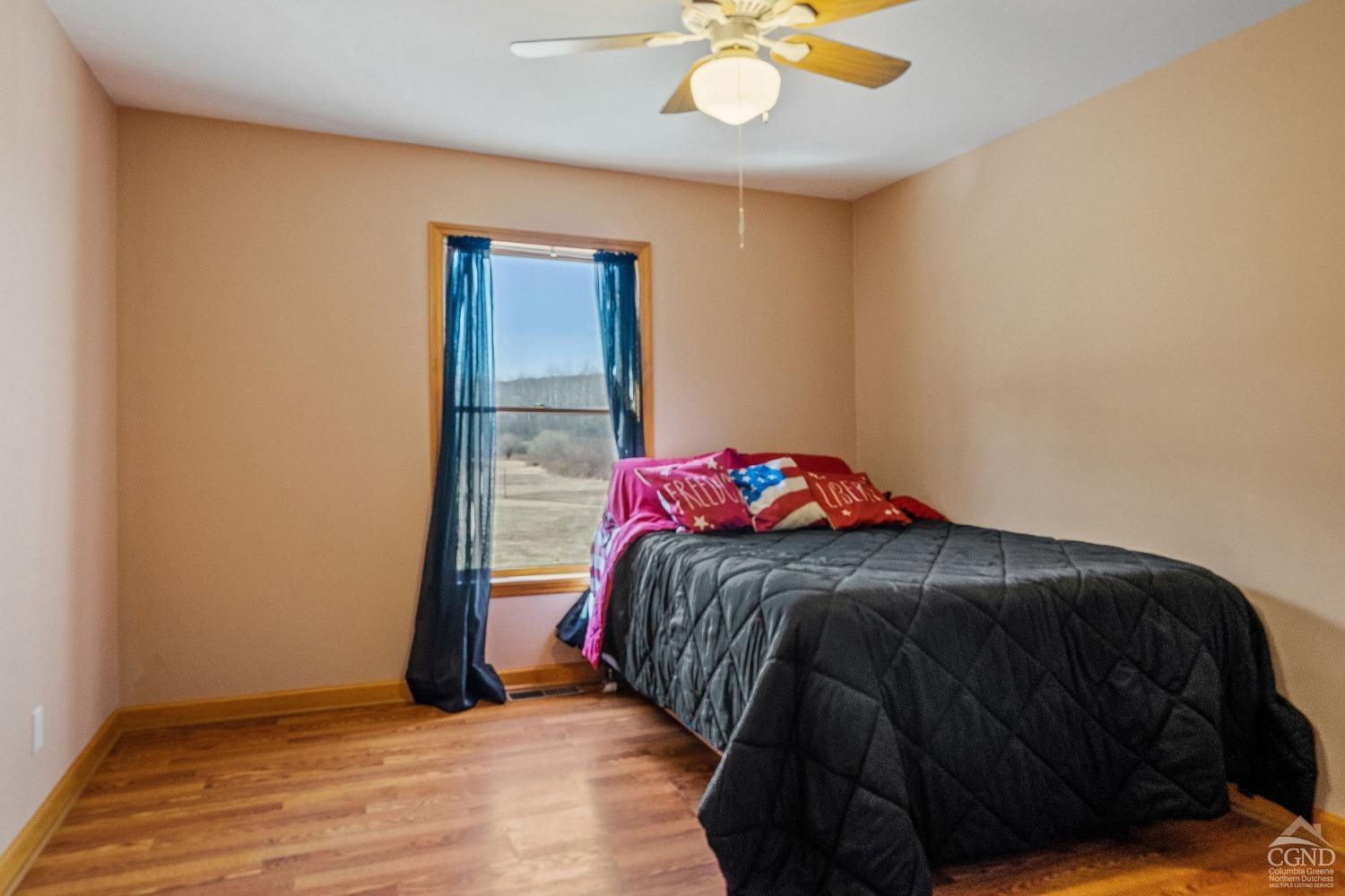 16 Deerfield Circle Copake, NY 12516 - Photo 15 of 40 a bedroom with a bed and a chandelier