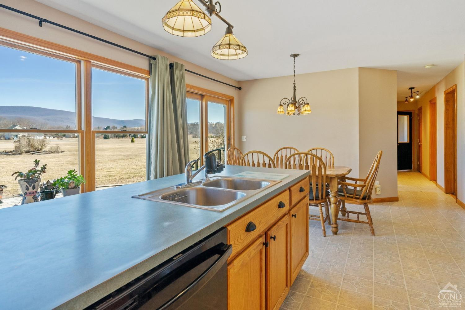 16 Deerfield Circle Copake, NY 12516 - Photo 9 of 40 a kitchen with a counter space a sink and chandelier