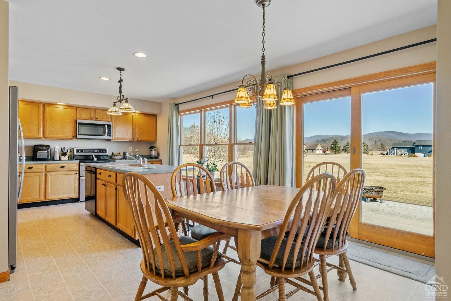 16 Deerfield Circle Copake, NY 12516 - Photo 10 of 40 a kitchen with stainless steel appliances granite countertop a stove top oven a sink a dining table and chairs