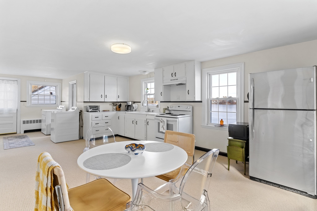 327 Bridle Path Worcester, MA 01604 - Photo 11 of 40 a kitchen with stainless steel appliances granite countertop a sink dishwasher a refrigerator and white cabinets with wooden floor