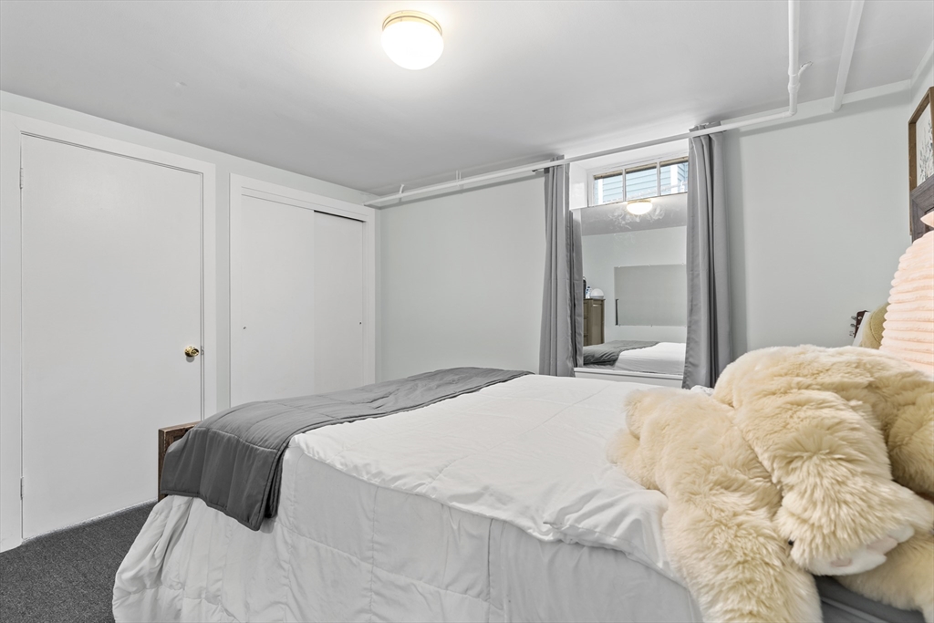 327 Bridle Path Worcester, MA 01604 - Photo 28 of 40 a bedroom with a bed and a mirror