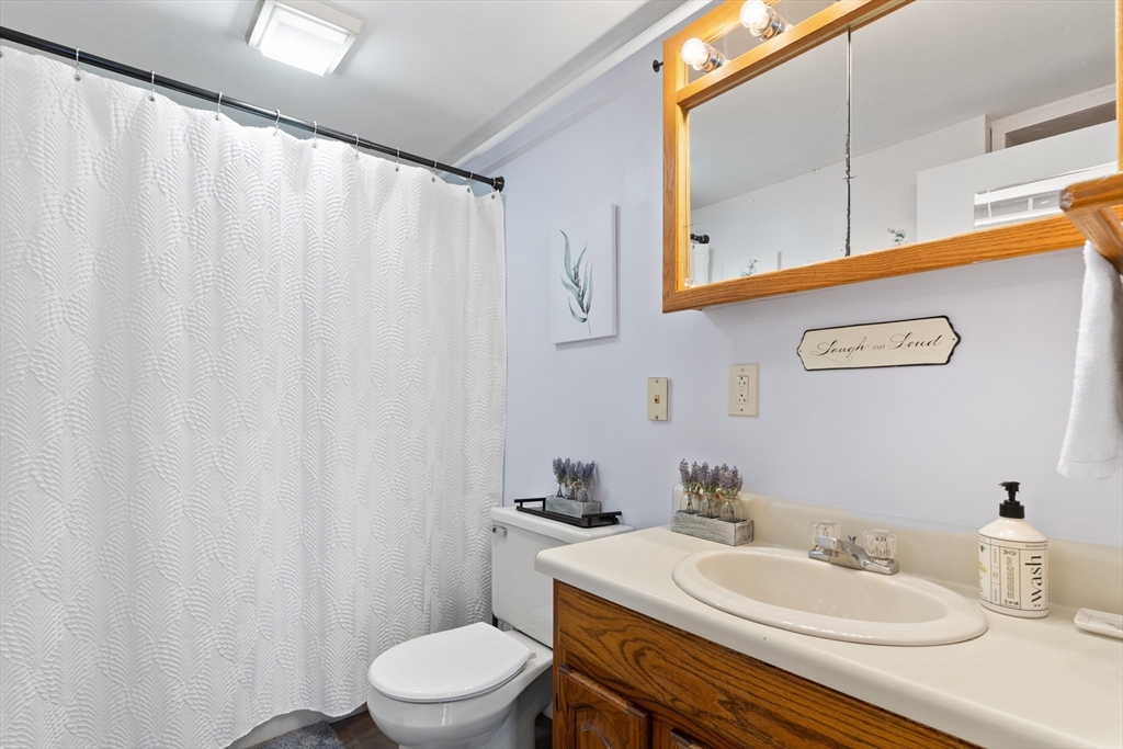 327 Bridle Path Worcester, MA 01604 - Photo 29 of 40 a bathroom with a sink a toilet and a mirror
